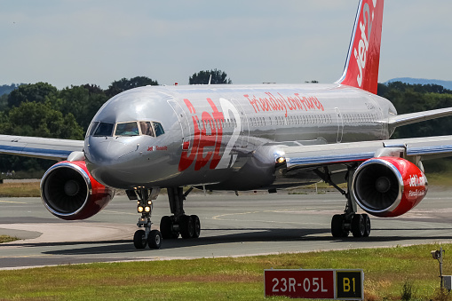 Manchester Airport, United Kingdom - 07 July, 2022: Jet2 Boeing 757 (G-LSAA) vacating runway 23R after landing.