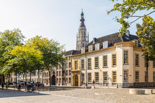 Breda, Netherlands, September 7, 2021; Stately buildings on the castle square with the tower of the Church of Our Lady in the background.
