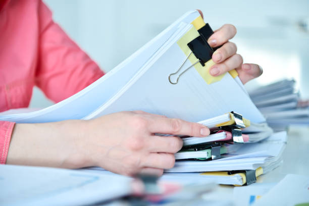 istock Woman hands holding stacks files 1416607537