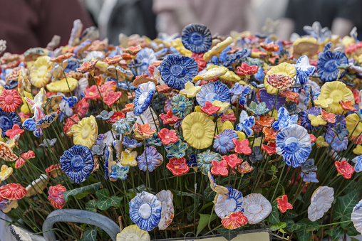 many colorful flowers on a grave after a funeral