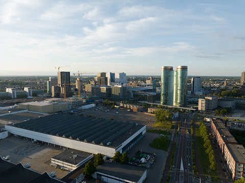Utrecht skyline and central station public transport infrastructure and business district. Aerial drone overhead view. Tall buildings and towers downtown.