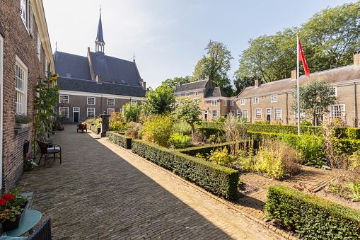 Beguinage in Breda with 29 houses around a herb garden with the Walloon church (Waalse kerk), in the background.