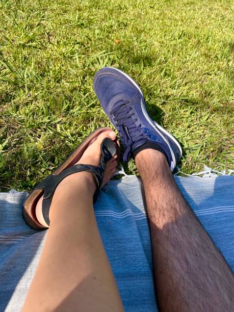 istock legs of people relaxing in a park 1416621905