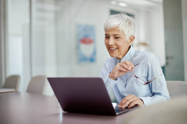 istock Smiling senior businesswoman working on a computer in the office. 1416626325