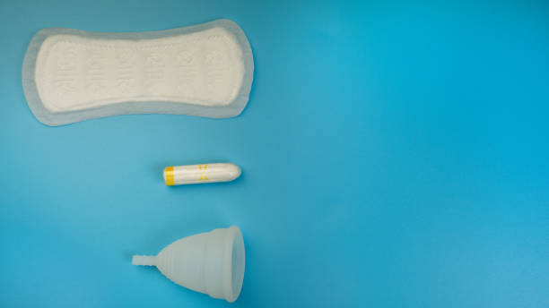 istock Menstruation products, pad, menstrual cup, tampon on a blue background. The view is flat. The concept of critical days, menstruation, women's health. copy space. 1416631844