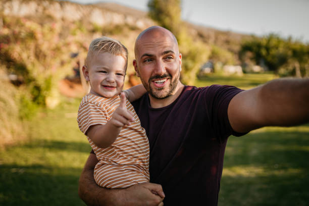 istock Father and baby boy having fun at the field 1416632189