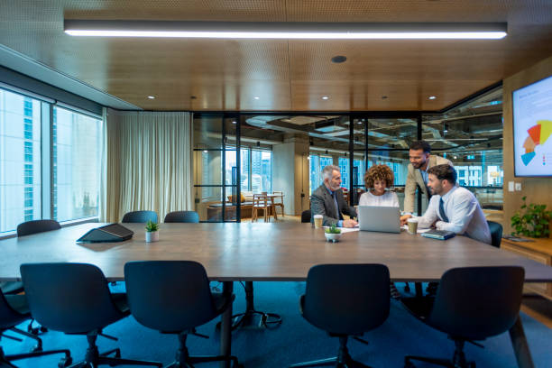 istock Four business people working on a laptop computer in an office conference room. 1416642970