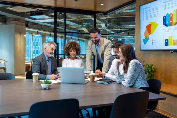 istock Five business people working on a laptop computer in an office conference room. 1416642977