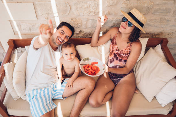 istock Family eating watermelon by the pool 1416653604