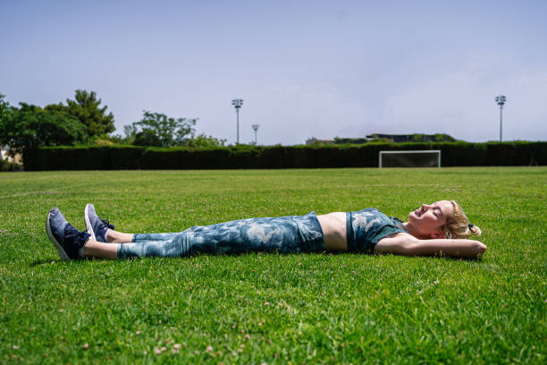 istock Calm sportswoman lying on grass during break 1416680666