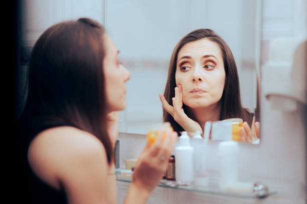 istock Woman Using a New Skin Care Routing Feeling Skeptical about Results 1416681790