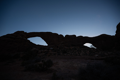 Tiny Sliver of The Moon Over The Spectacles in Arches National Park