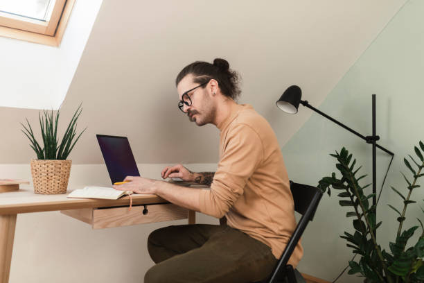 istock Young man making plans for his business at home office 1416702997