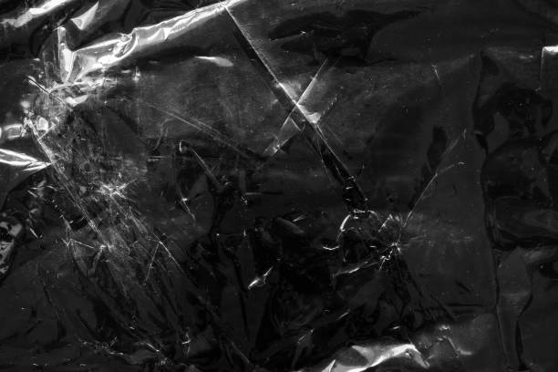 istock transparent plastic bag film wrap overlay texture on black background 1416703194