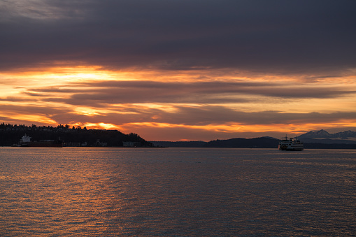 A Ferry crossing Elliott bay during a vivid sunset.