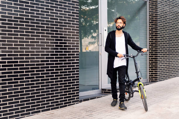 istock man leaving his front door walking with his bike 1416706840
