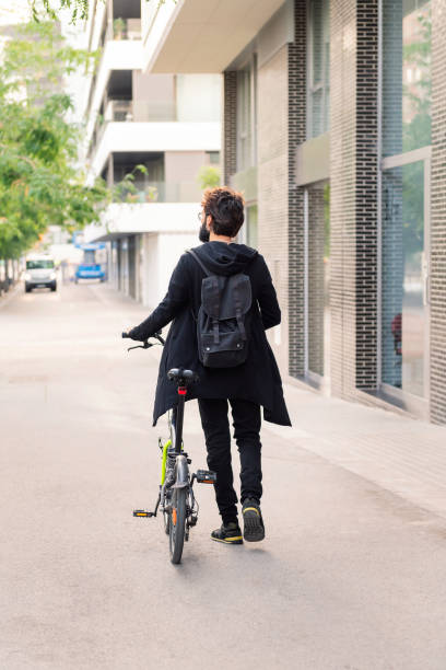 istock unrecognizable caucasian man walking with his bike 1416706843