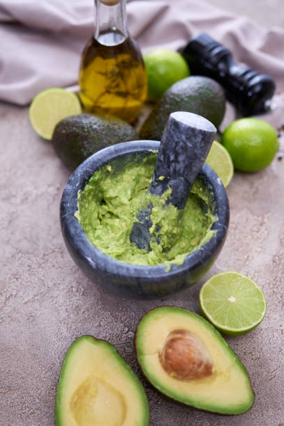 istock making guacamole - crushed avocado in marble mortar on grey concrete table 1416706893