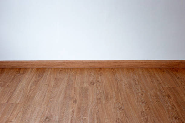 istock Laminate wood floor with blank white wall 1416713252