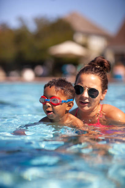istock Swimming Instructor Teaching 3 year old how to Swim 1416713850