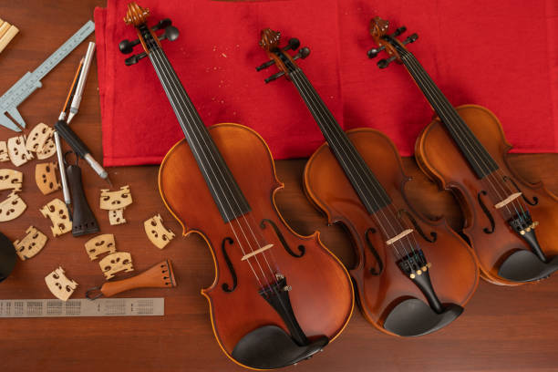 istock Top view of three violins in a workshop 1416713940
