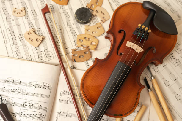 istock Violin and bow with tools and music sheets in a workshop 1416713967