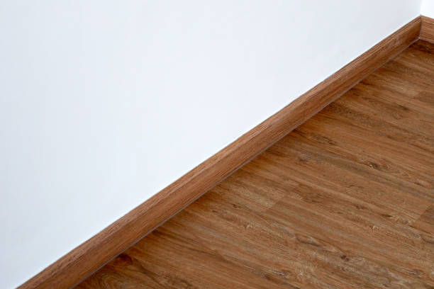 istock Laminate wood floor with blank white wall 1416715759