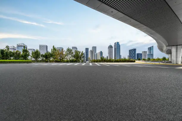 Photo of empty asphalt road with city skyline background in china