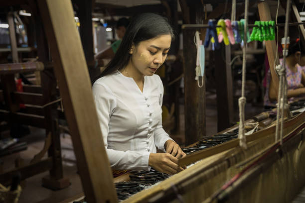 local Amarapura woman weaving hand-made tradional myanmar fabric at weaving factoryin Mandalay Myanmar local Amarapura woman weaving hand-made tradional myanmar fabric at weaving factoryin Mandalay Myanmar Amarapura stock pictures, royalty-free photos & images