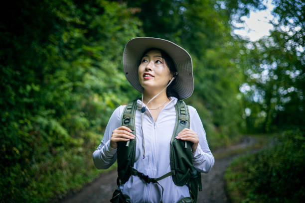 istock Woman Hiking in Forest Road 1416741652