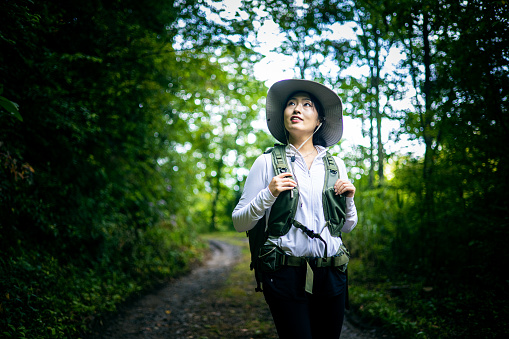 Woman Hiking in Forest Road