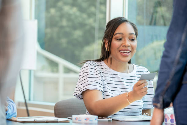 istock Mid adult volunteer checking voters identification card. 1416775605