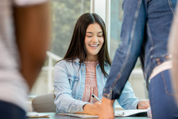 istock Young volunteer engaging in conversation while assisting voters. 1416776825