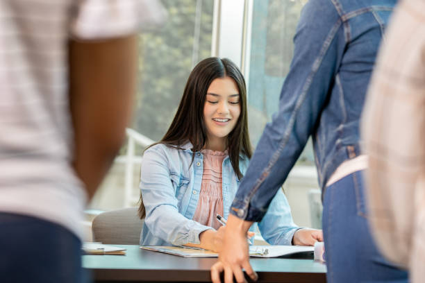 istock Young volunteer engaging in conversation while assisting voters. 1416776832