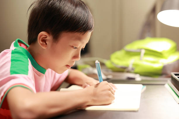 istock Little boy painting and writing 1416778048