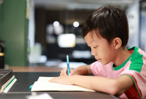 istock Little boy painting and writing 1416778054