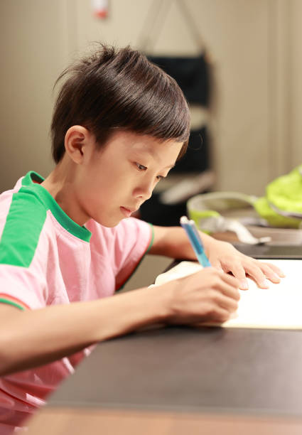 istock Little boy painting and writing 1416778058