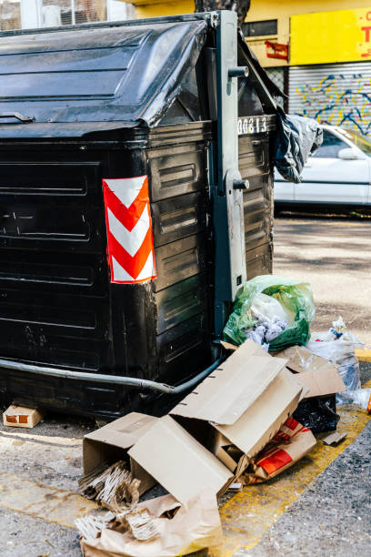 istock Garbage dumped on the street next to a street waste container. 1416778168