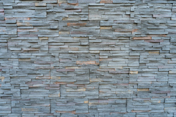 Background arrangement of stones or slabs of different shapes and colors on a wall. A Background arrangement of stones or slabs of different shapes and colors on a wall. stonewall creek stock pictures, royalty-free photos & images