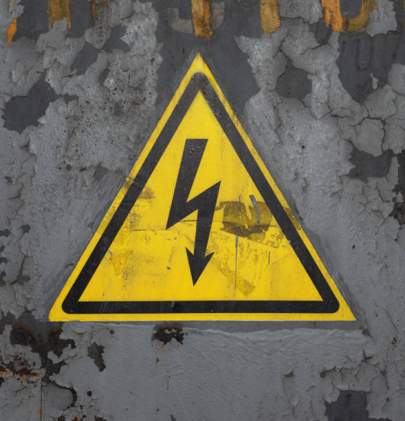 istock High Voltage Sign. Black Arrow in Yellow Triangle on Rusty Gray Painted Metal Surface. 1416781690