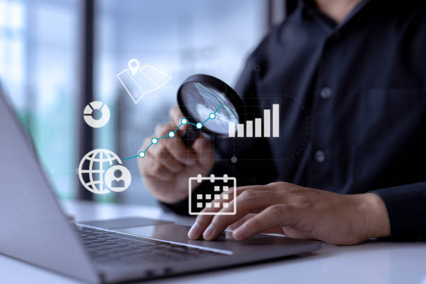istock Business analyst with magnifying glass analyzing graphs and charts for market expansion, financial reports, investment data, or sales information concepts. 1416783118