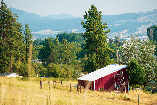 Rural red barn with mountains in distance