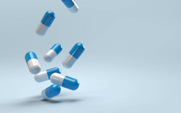 istock Falling pills on a blue background. Antibiotics. 1416796413