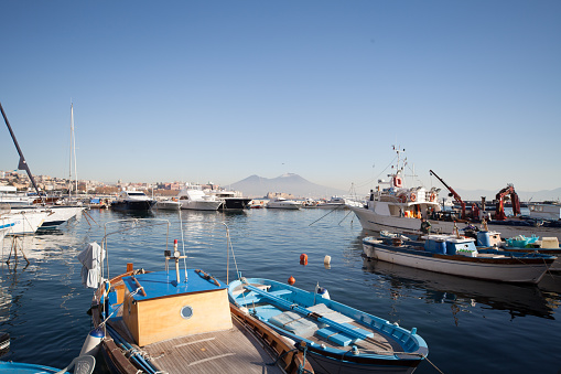 Napoli - May 12, 2017: Naples and Vesuvio seen from Harbor with fishing boats
