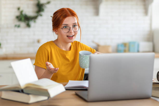 istock Online conference. Young Caucasian woman student or freelancer working using laptop, communicate remotely with employees or study online sitting at home. Learning, distance education 1416811397