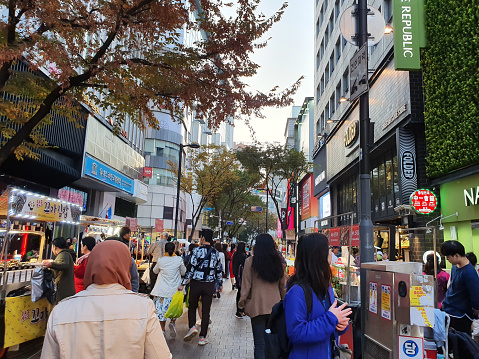 Seoul, South Korea - November 04, 2019: People walking at Myeongdong street market in Seoul, Myeong Dong district is a popular shopping and street food market in Seoul city.