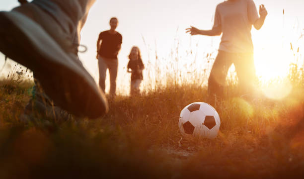 istock Happy family playing soccer 1416818195