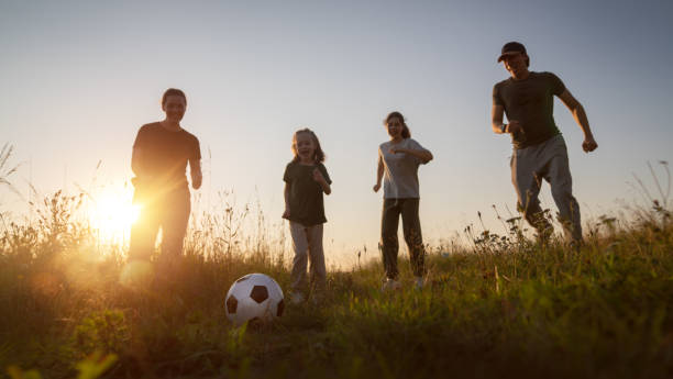 istock Happy family playing soccer 1416818201