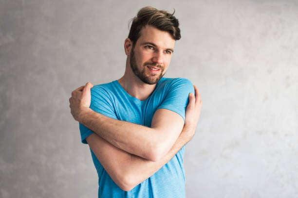 istock Smiling loving young man hugging oneself 1416818272