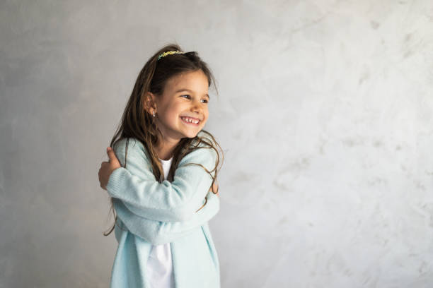 istock Smiling loving young girl hugging oneself 1416818312